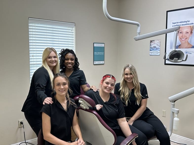 Dental team smiling in a dental office.